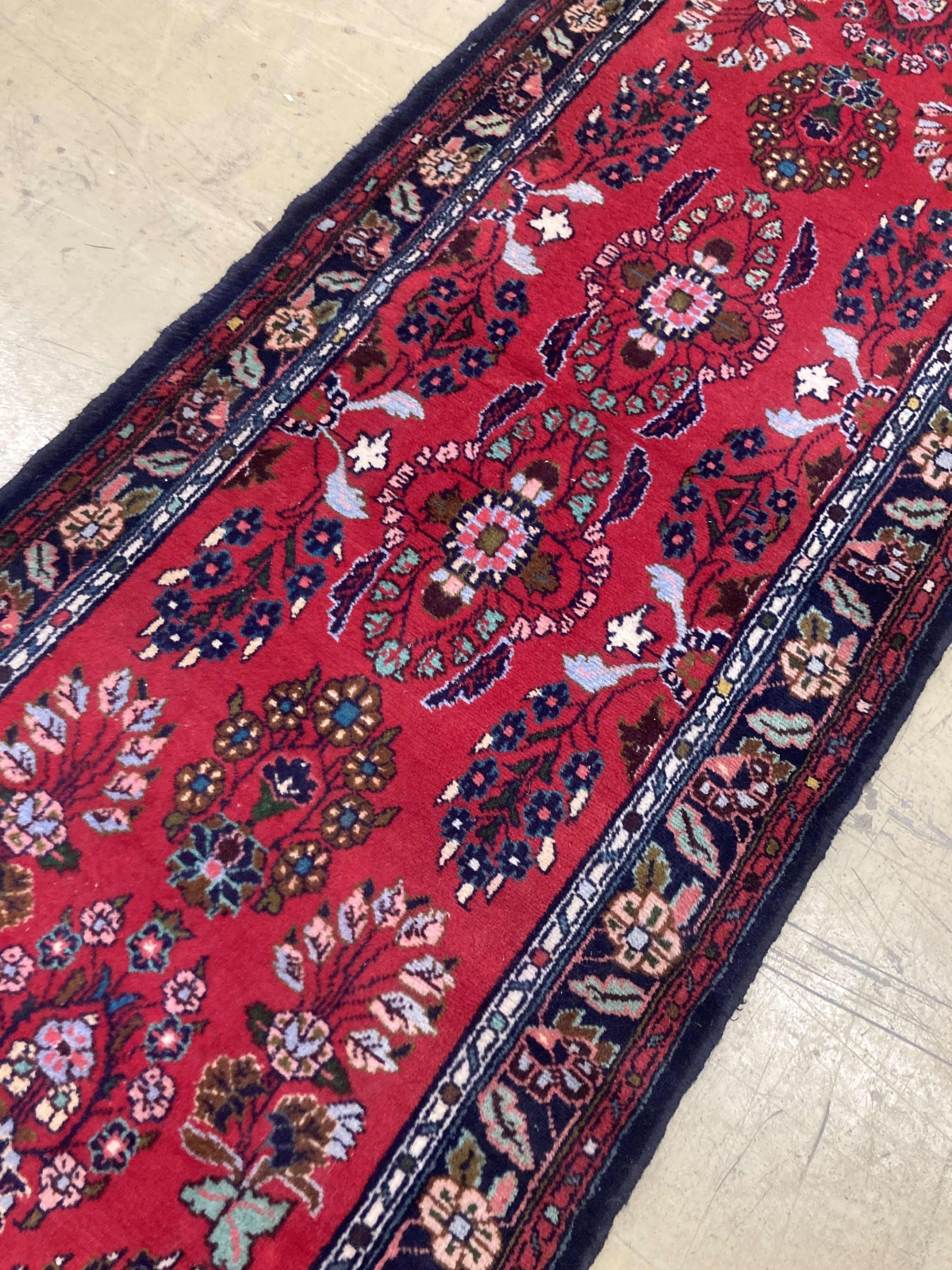 A Hamadan red ground runner with floral design, 280 x 84cm